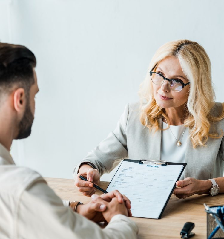 selective-focus-of-recruiter-in-glasses-holding-pen-near-clipboard-and-looking-at-bearded-man-q70ef5m4r95truettqa2krjbkmzz0chcbydz7sugg0